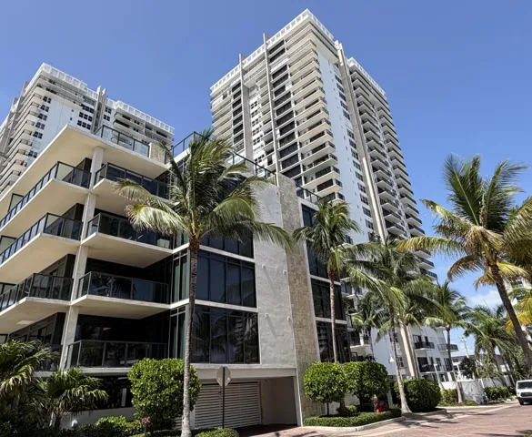 Modern high-rise condominium featuring multiple private balconies with glass railings