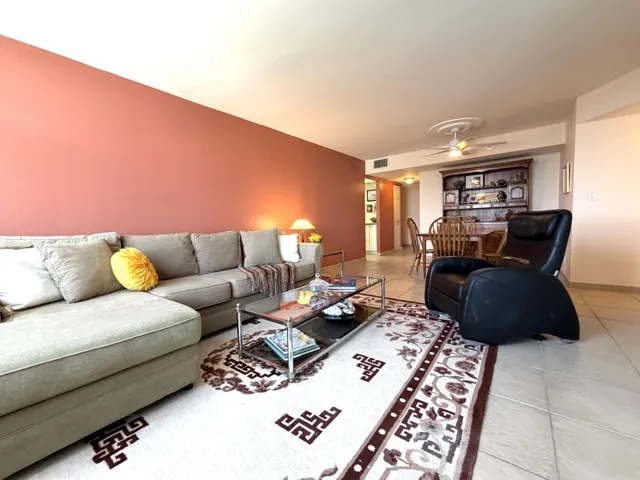 Open-concept living area with tile flooring and a ceiling fan