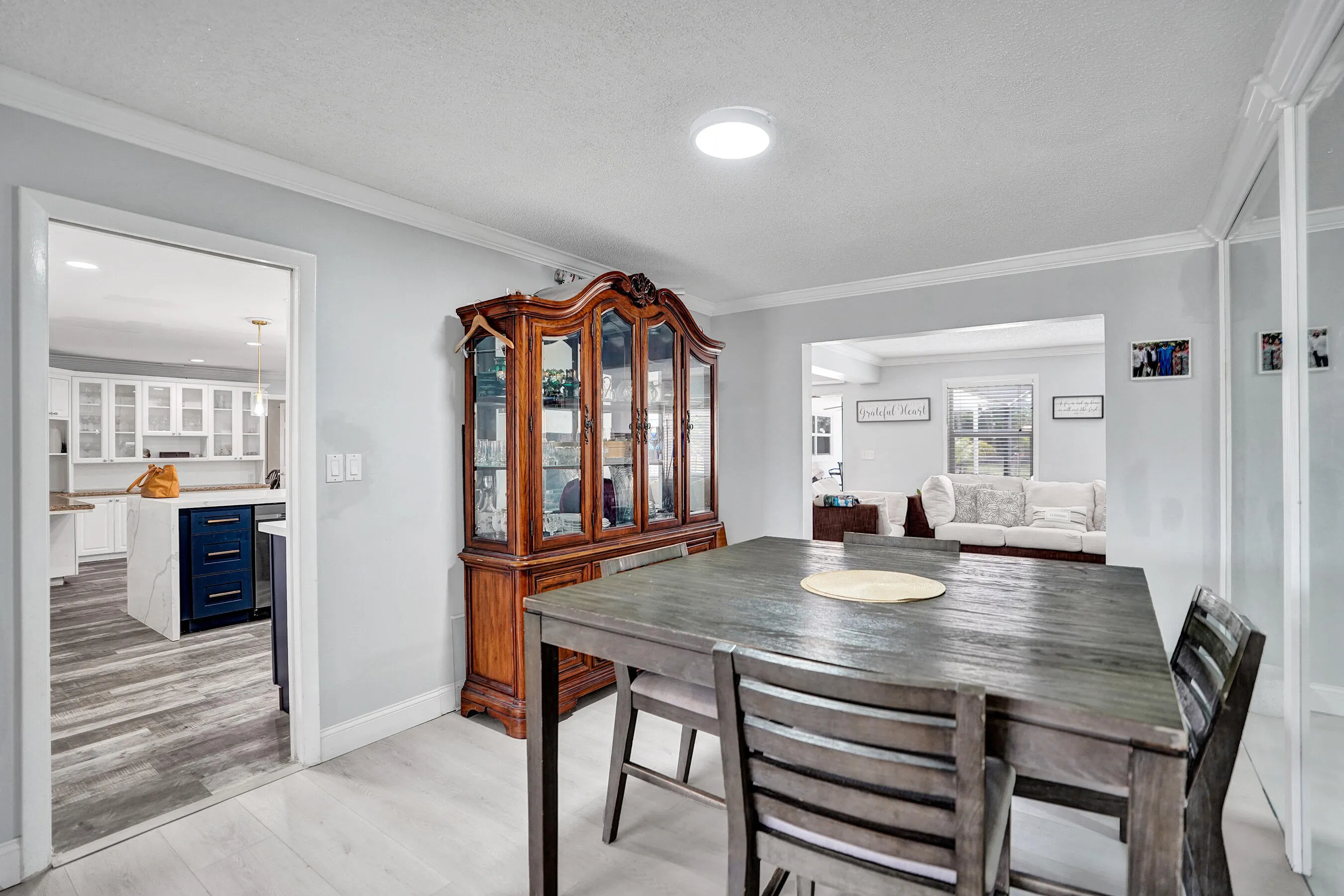 Open concept interior featuring light wood-finish flooring and crown molding