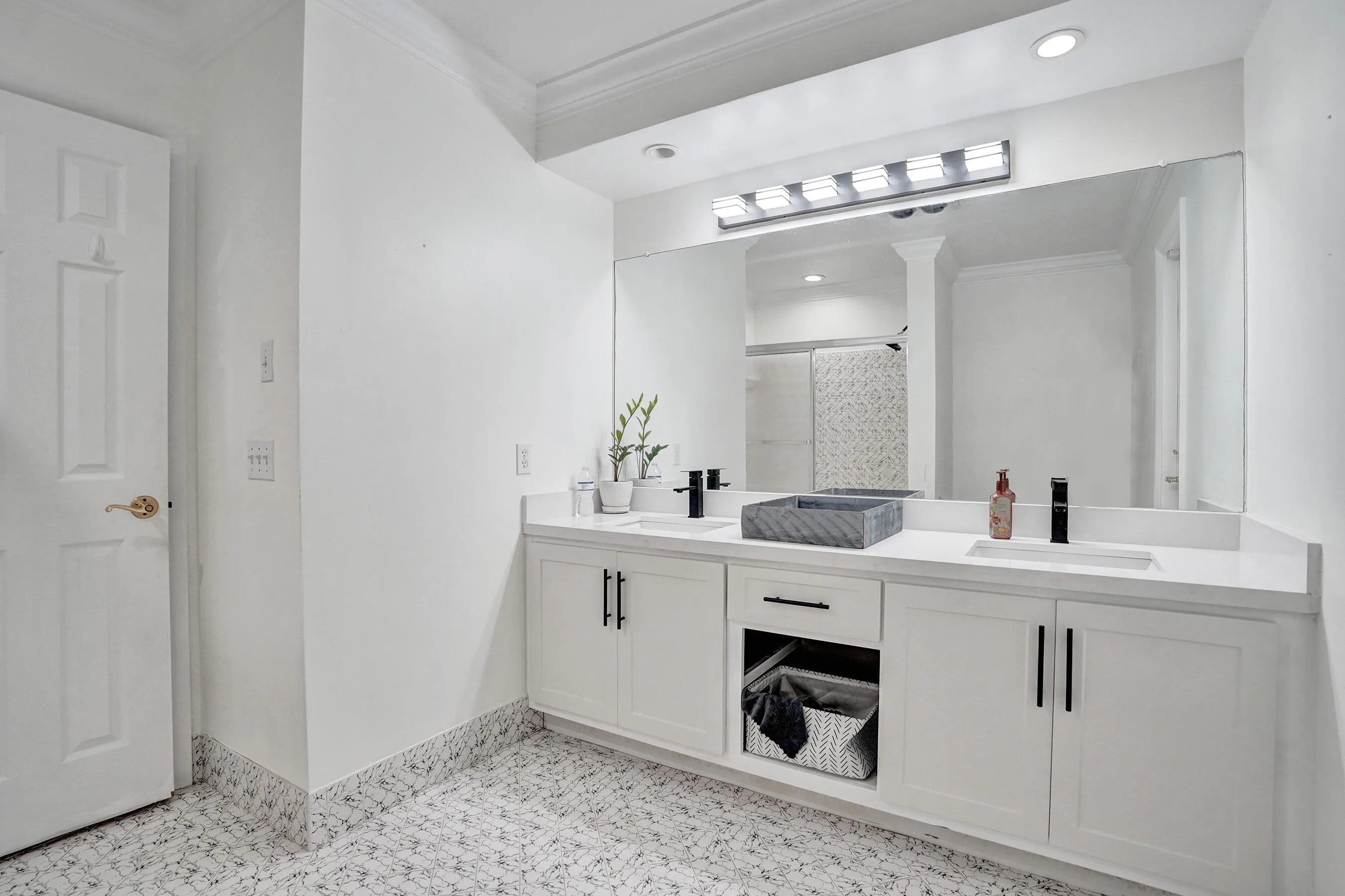 Dual vanity with rectangular undermount sinks, white countertops, and matte black faucets