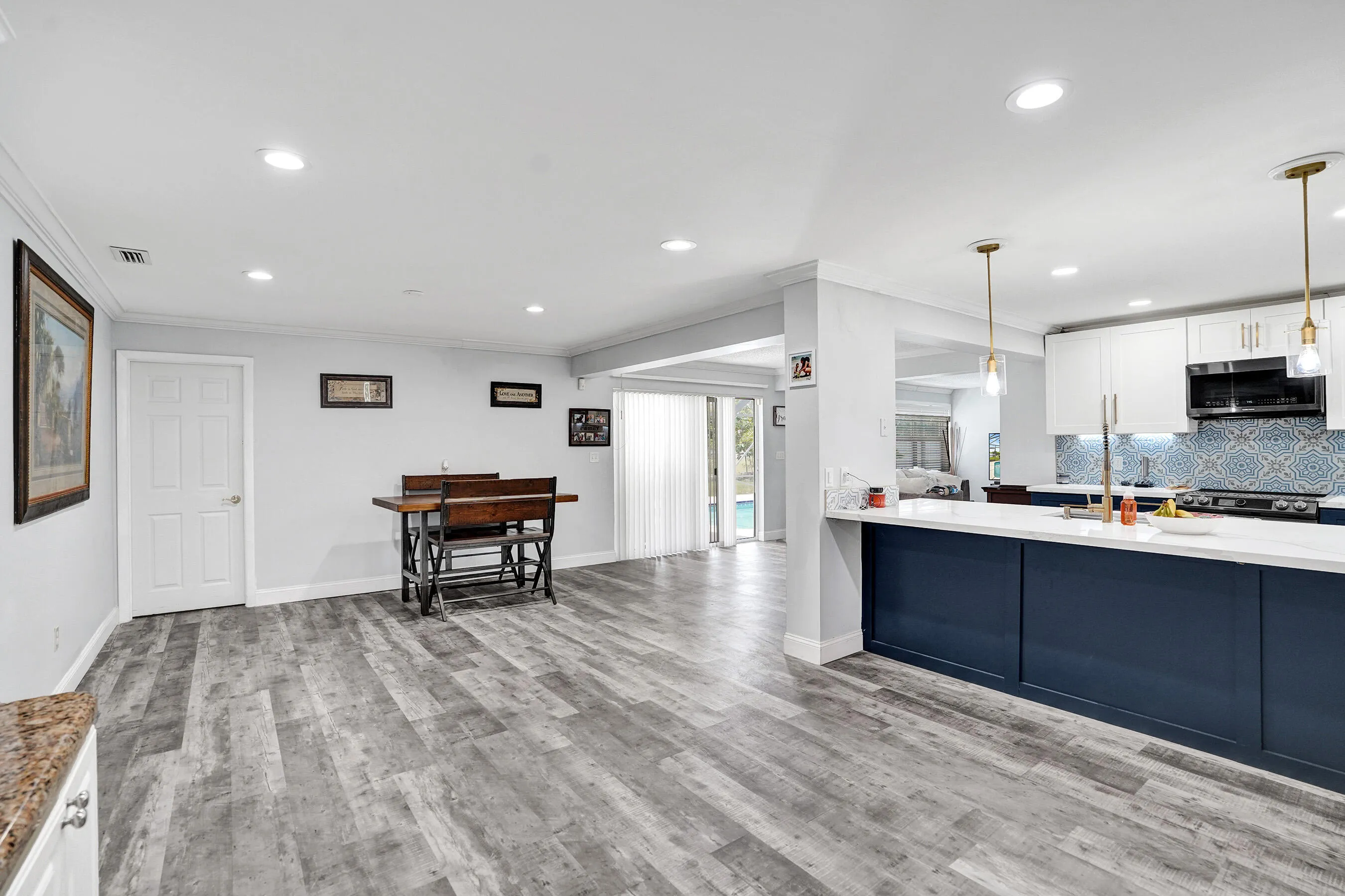 Open-concept kitchen and living area featuring wood-finish flooring