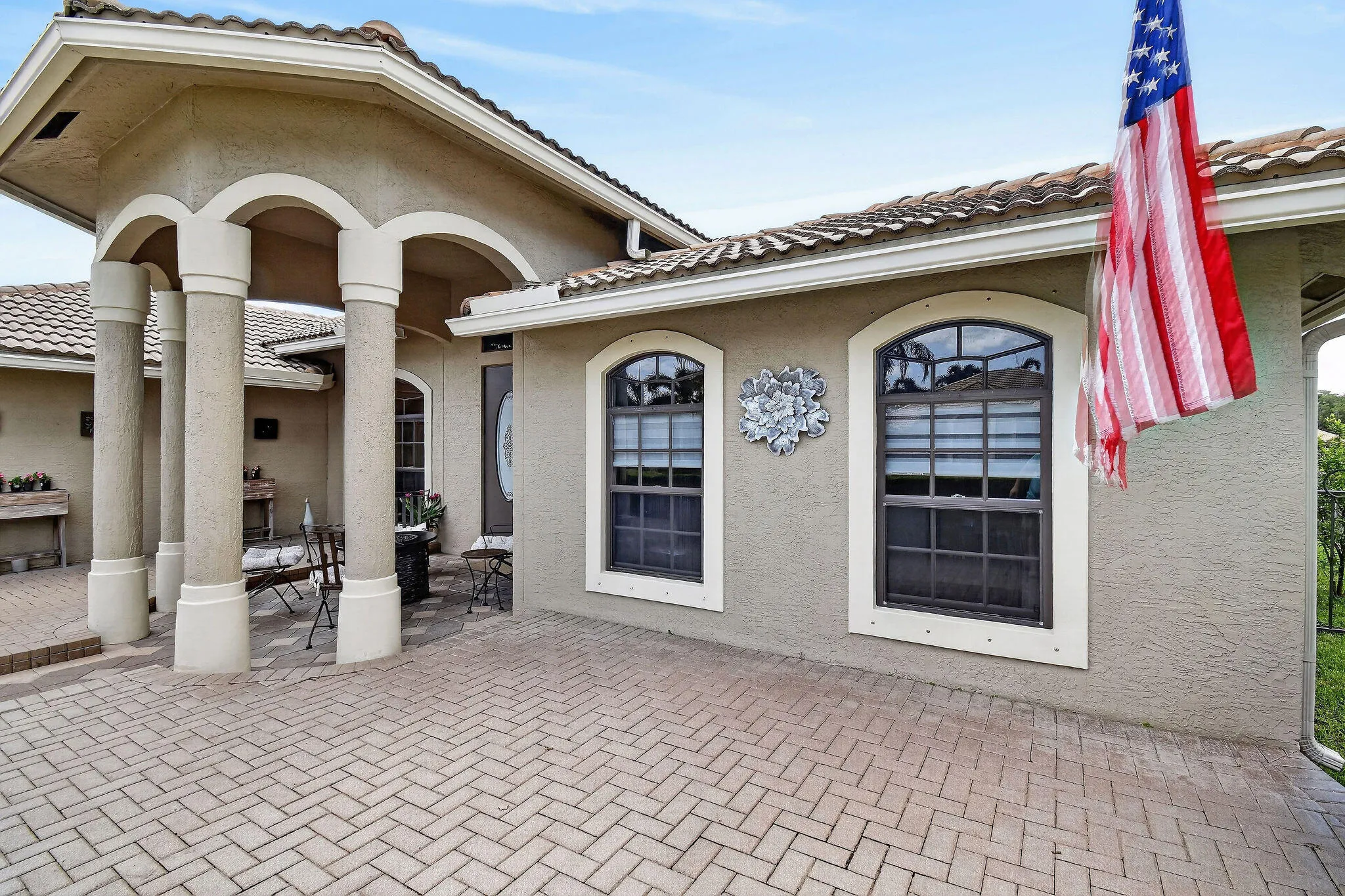 Raised paver patio on each side of the entry.