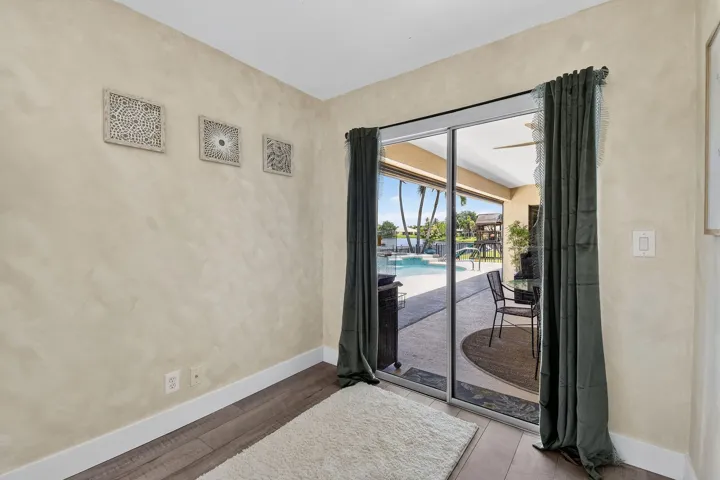 Bedroom 4 with sitting area and sliders to the porch and pool.