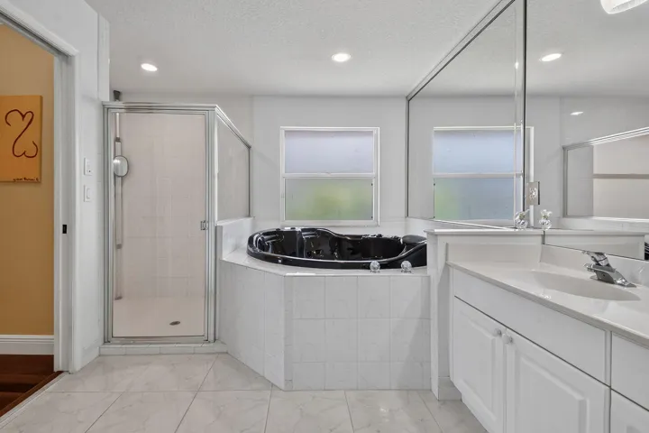 Primary bath with separate shower and hot tub.