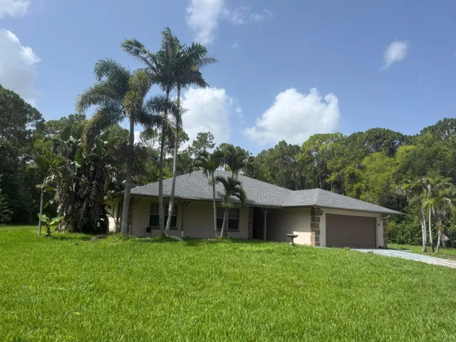 Single-story residence featuring a two-car garage with a muted brown door