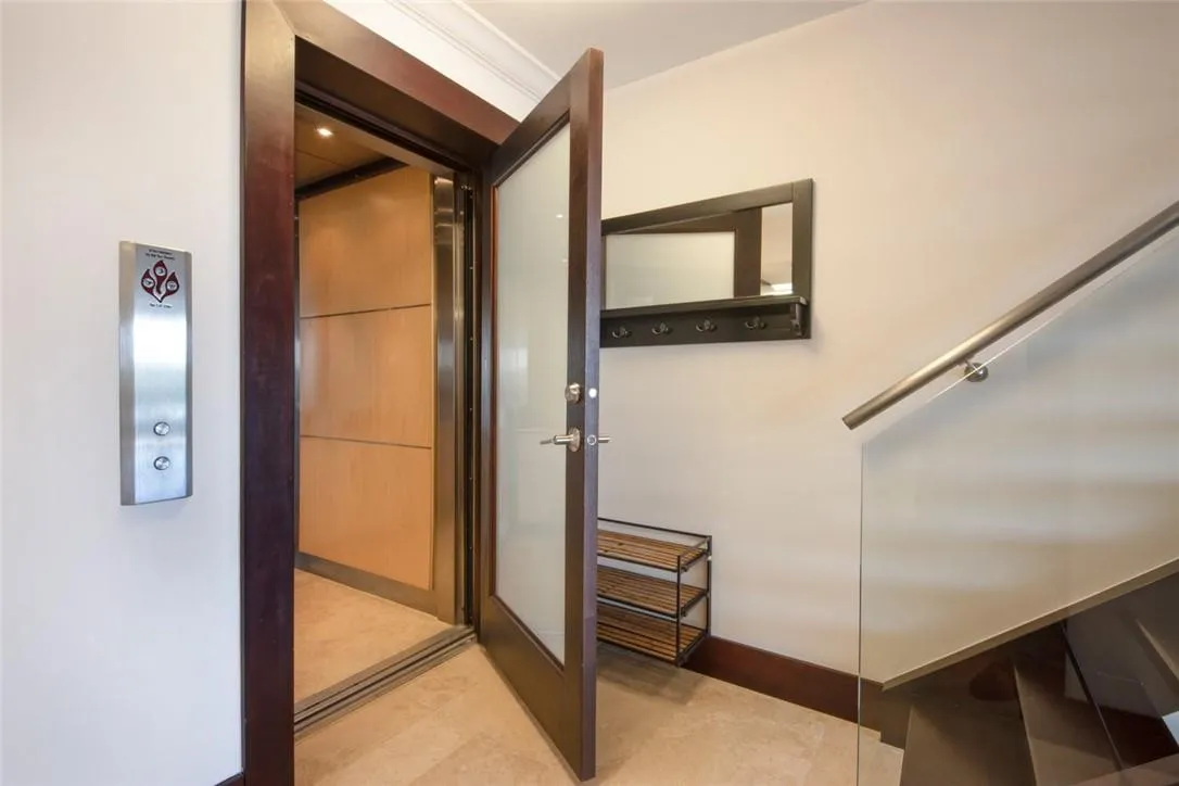Elevator with exclusive access to the townhouse's main level, where kitchen, dining room, living room, and, laundry room are located.