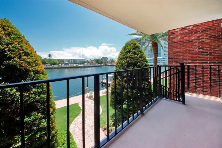 Balcony on second level with the staircase going down to the boat slips and the pool
