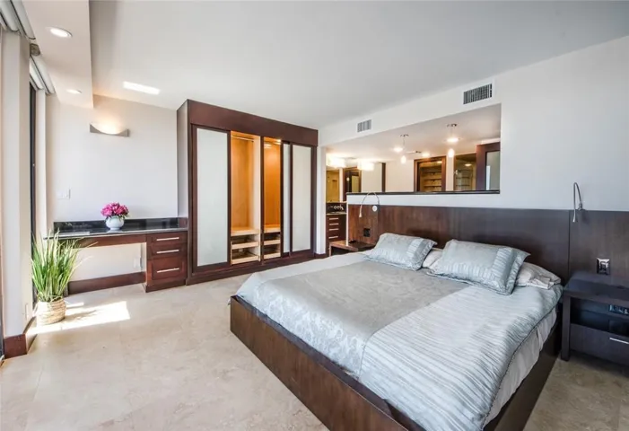 Master bedroom with desk, closet cabinetry and en suite bathroom. This bedroom with the bathroom and closets occupies the entire third level of the townhouse.
