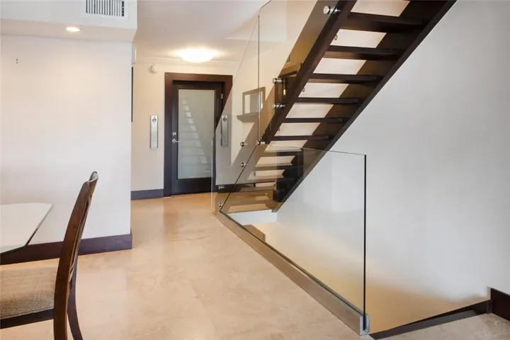 View of the entrance from the elevator, the stairs going to the 3rd level (master bedroom) and the stairs going to the first level where there are 2 bedrooms and a bathroom,