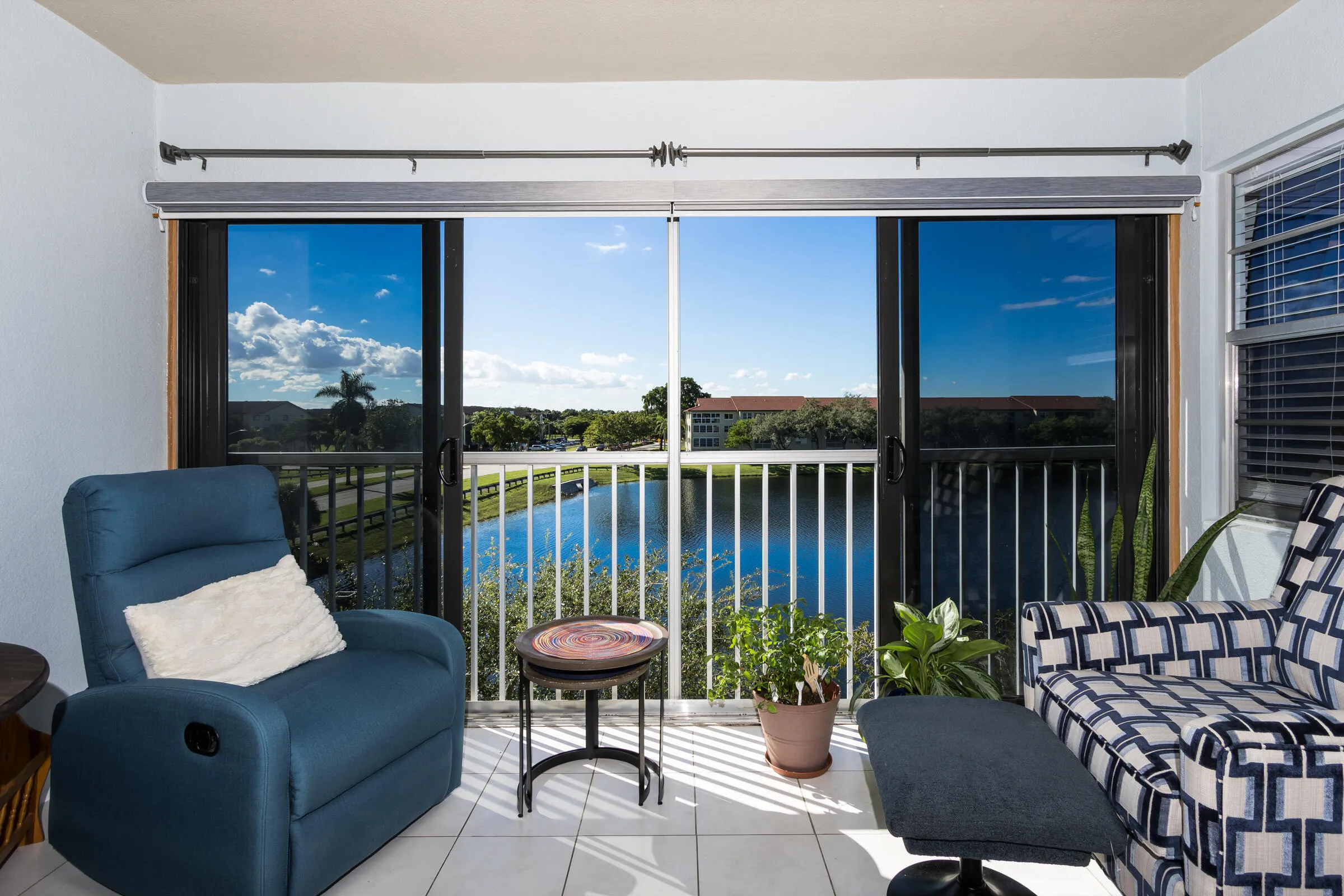 Tiled Balcony, Hurricane Impact Windows/Tinted sliding glass doors.