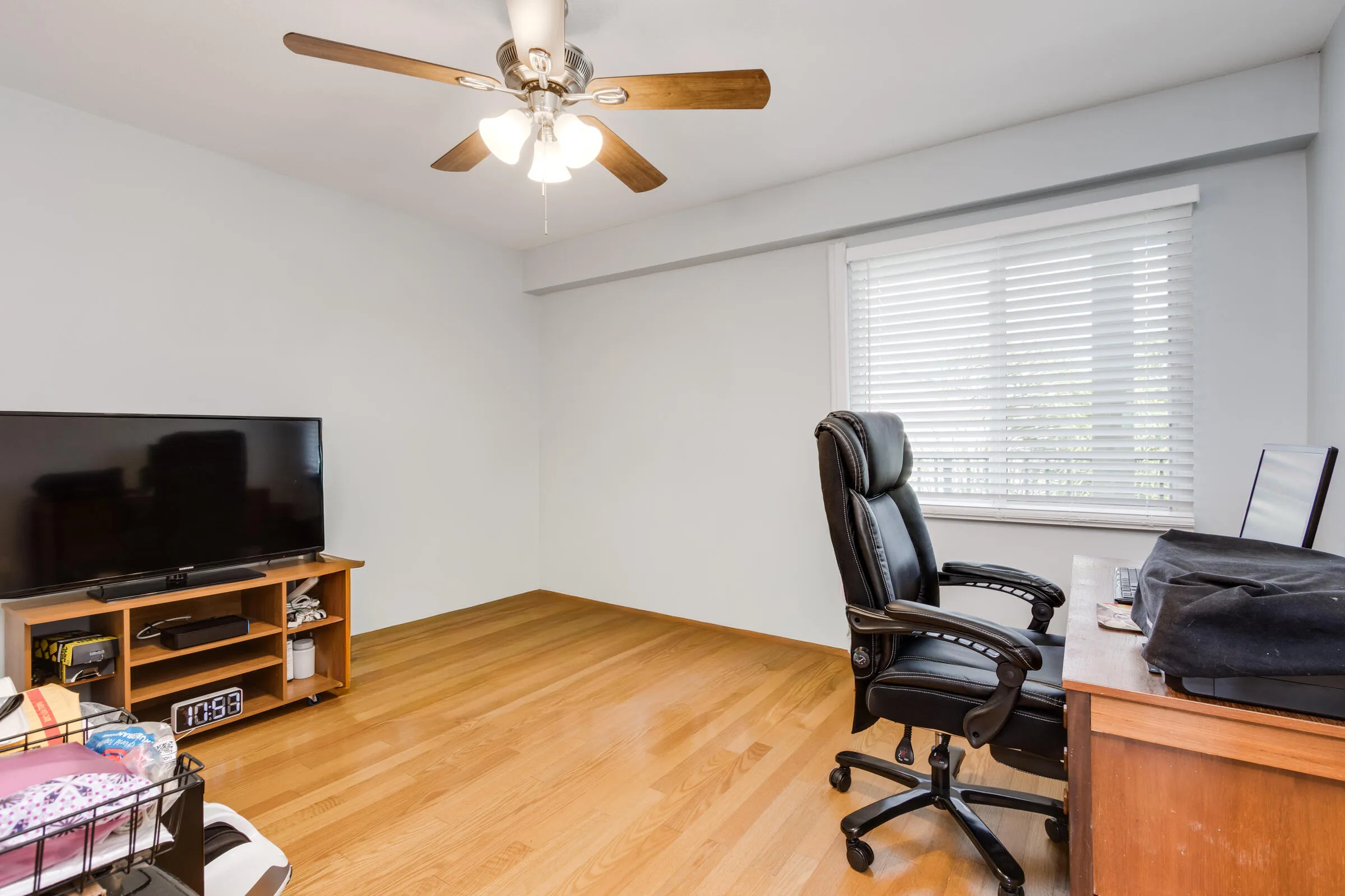 2nd bedroom /or combination office/den with wood flooring - blinds & ceiling fan/light.