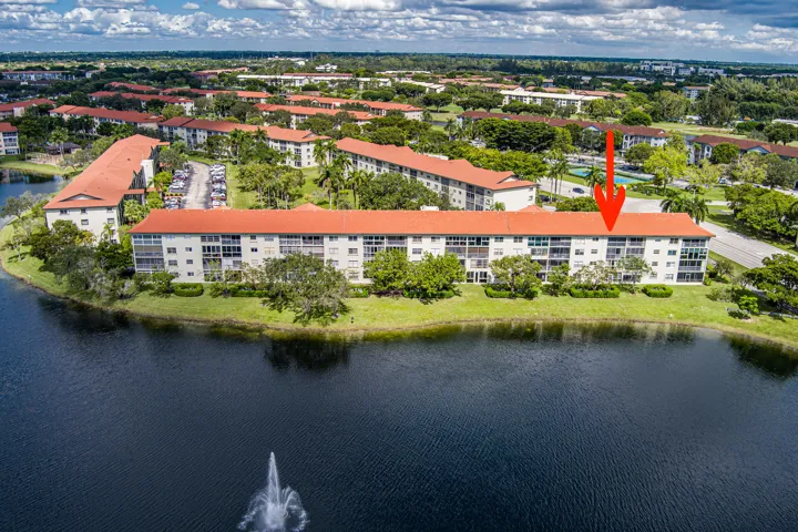Exterior Aerial View of Bldg. E - Red arrow indicates location of unit 403E overlooking wide lake views.