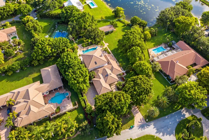 Aerial perspective showcasing multiple properties, each featuring a private swimming pool