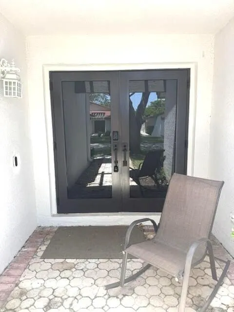 Elegant double front entryway doors made of strongest impact rated materials.