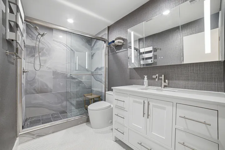 The guest bath offers a high-quality 48 inch solid wood vanity with white quartz top, a 48" LED medicine cabinet, a new syphonic action skirted toilet, multi-function Lefton faucet, an electric towel warmer and filtered shower with a detachable 10-foot handheld showerhead.