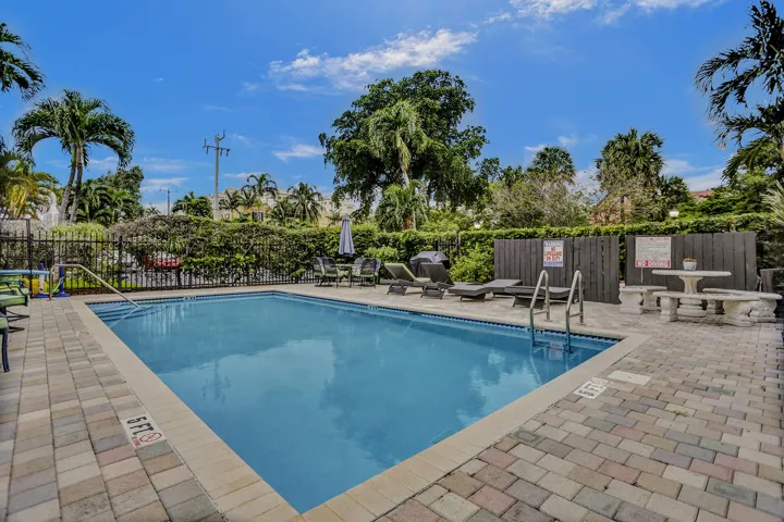 Outdoor swimming pool with integrated steps and metal handrails