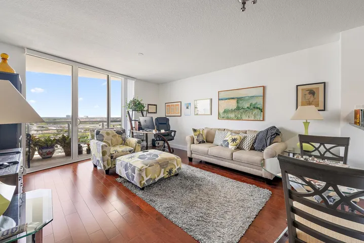 Tons of natural light from the floor-to-ceiling impact sliders. (Previous tenant's furniture)