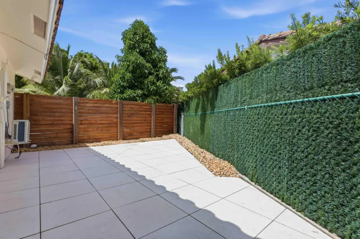 Spacious outdoor patio featuring large square pavers