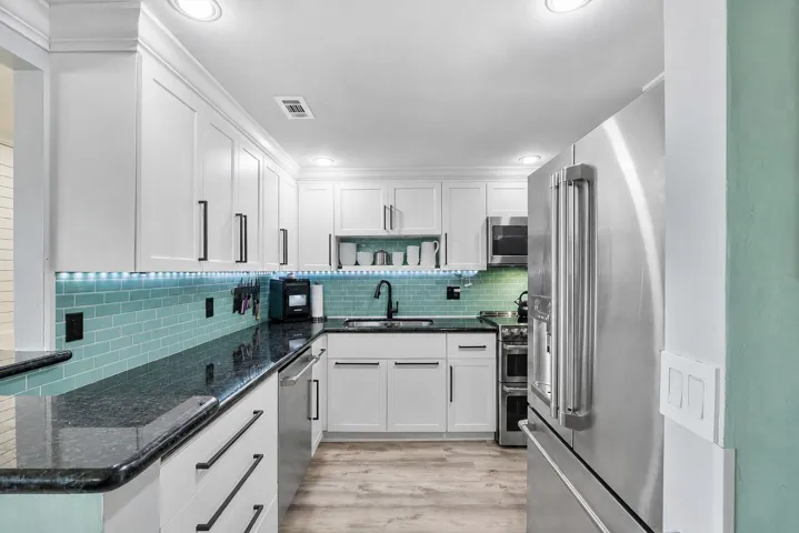 The kitchen is newer with real wooden soft closing cabinets and drawers with modern stylish hardware, pullouts and shelving