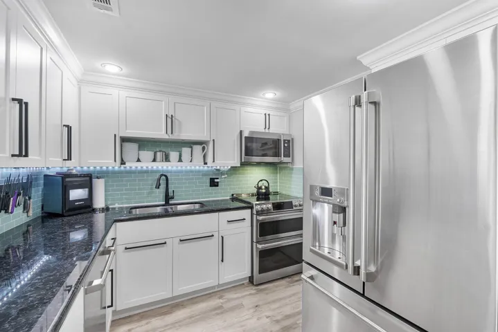 All stainless steel top of the line GE upgraded matching appliances, Induction stove with a convention oven and a regular oven, The refrigerator has a built in Kuerig coffee maker & hot- boiling water dispenser