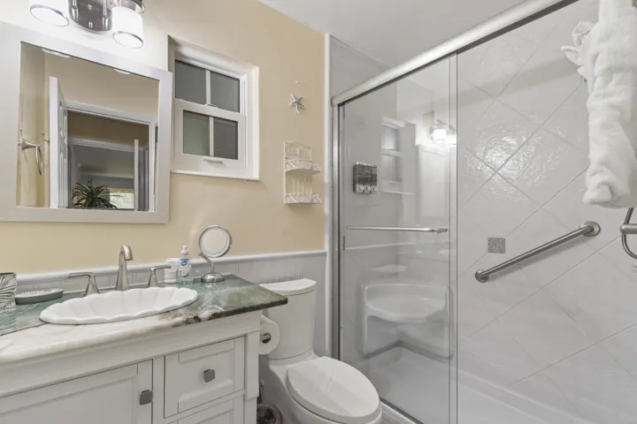 Master bath shower features handle bar and seating area