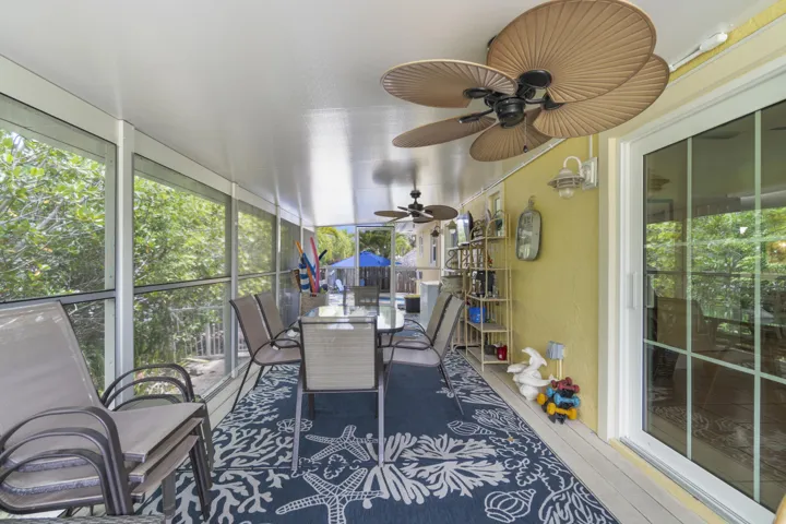 Lanai features screened dining area for 6 to the sounds of morning doves, pelicans and wild life thrashing courtesy of nature that thrives off the mangroves, sea grape trees and button wood lining the property.