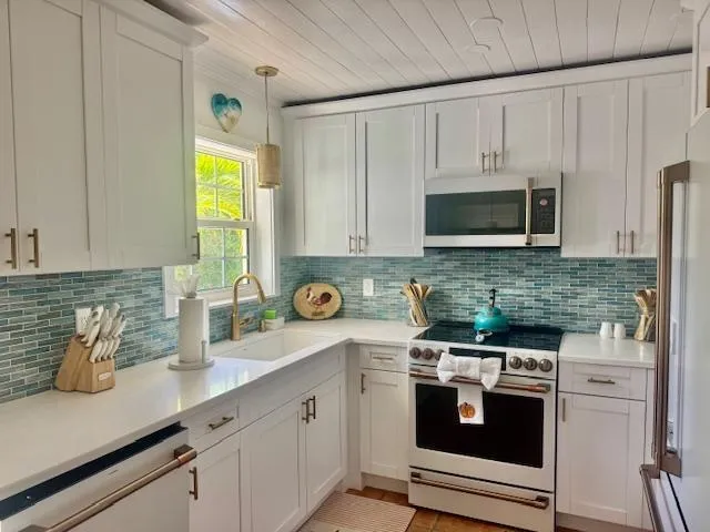 White shiplap ceiling through kitchen and entire home for a classic crisp yet beachy atmosphere.