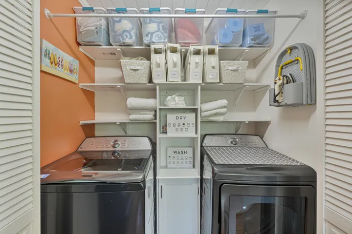 Laundry with full size GE washer, dryer and extra linens