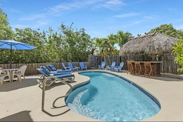 Pool area features ultimate privacy with custom tiki bar