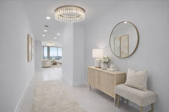The entryway of the condo, chandelier not included. Virtually staged.