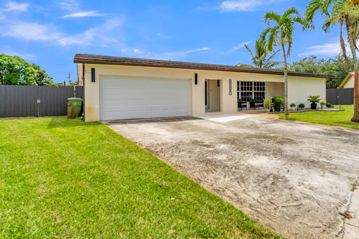 Single-story residence featuring a two-car garage, stucco exterior, and a covered entry