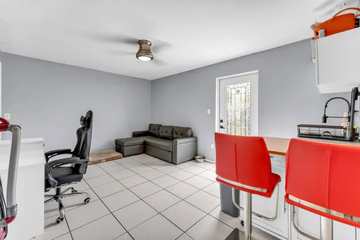 Bright interior space featuring light gray walls and white tile flooring