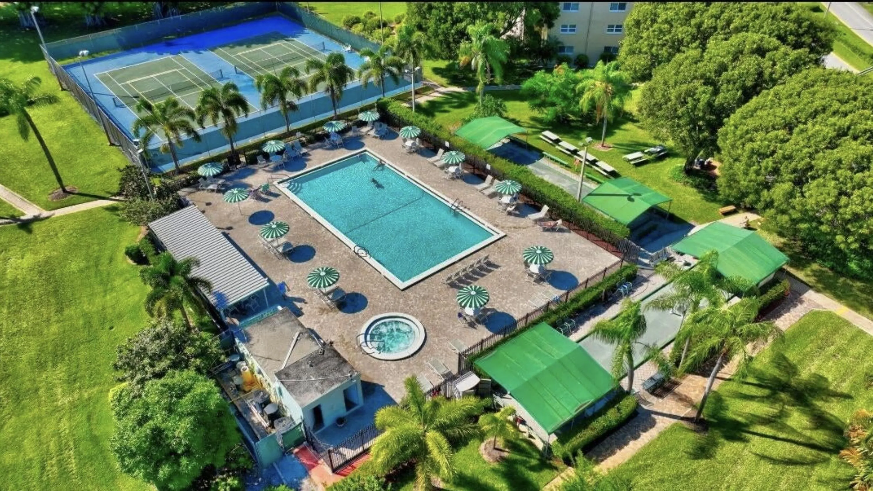 Central swimming pool with integrated spa and surrounding lounge seating