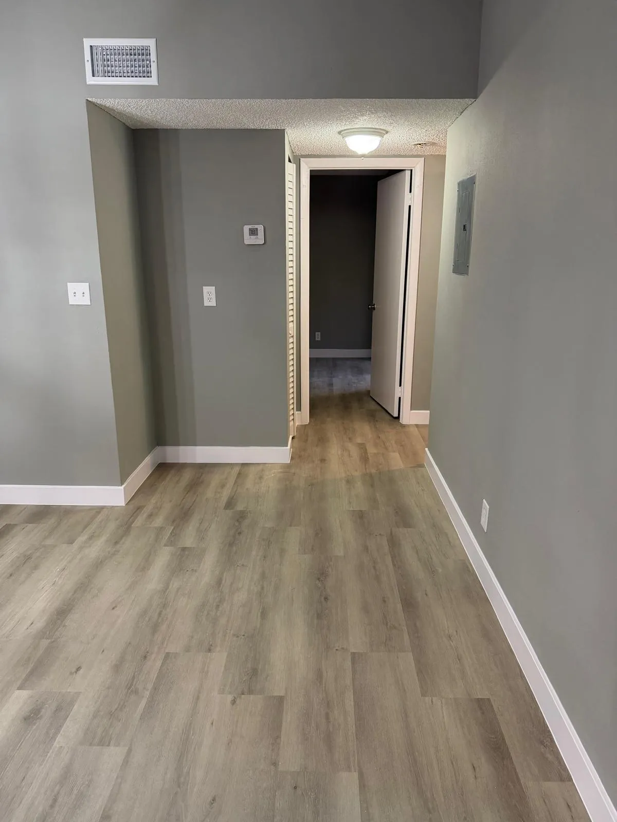 Light wood-finish flooring extending through the space