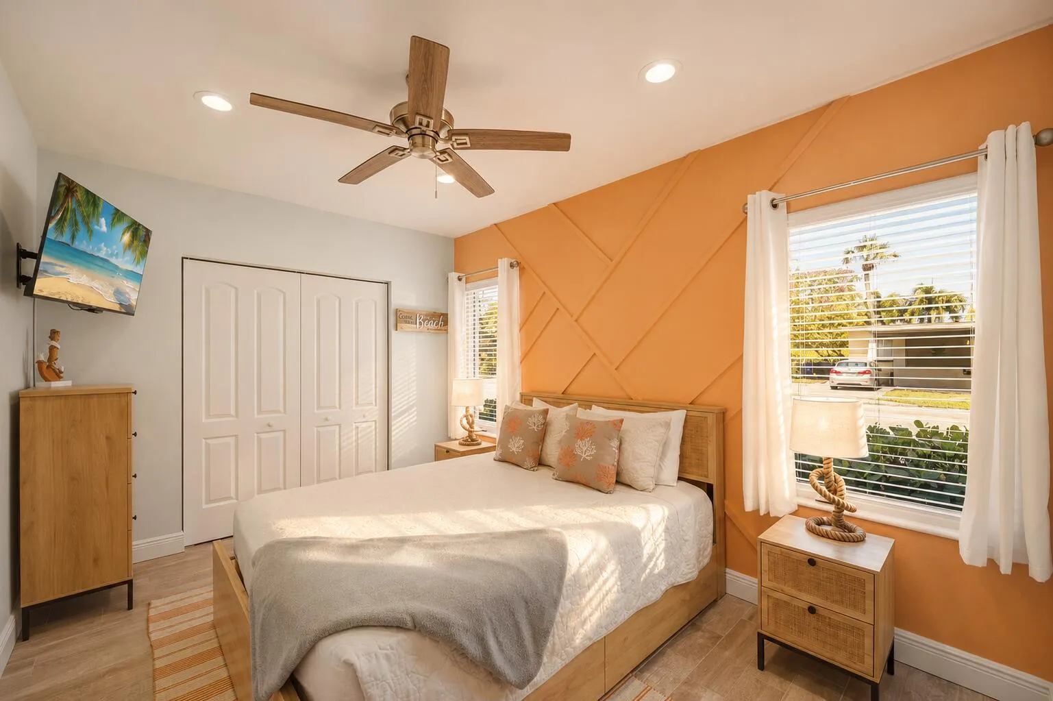 Bedroom featuring a decorative accent wall, ceiling fan with integrated lighting, recessed ceiling lights, bi-fold closet doors, and wood-finish flooring