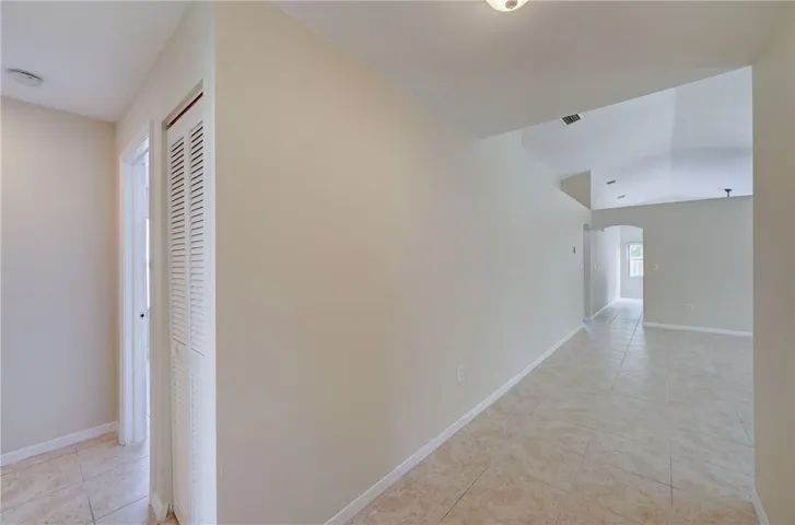 from entry view through huge great room into kitchen family room entry door