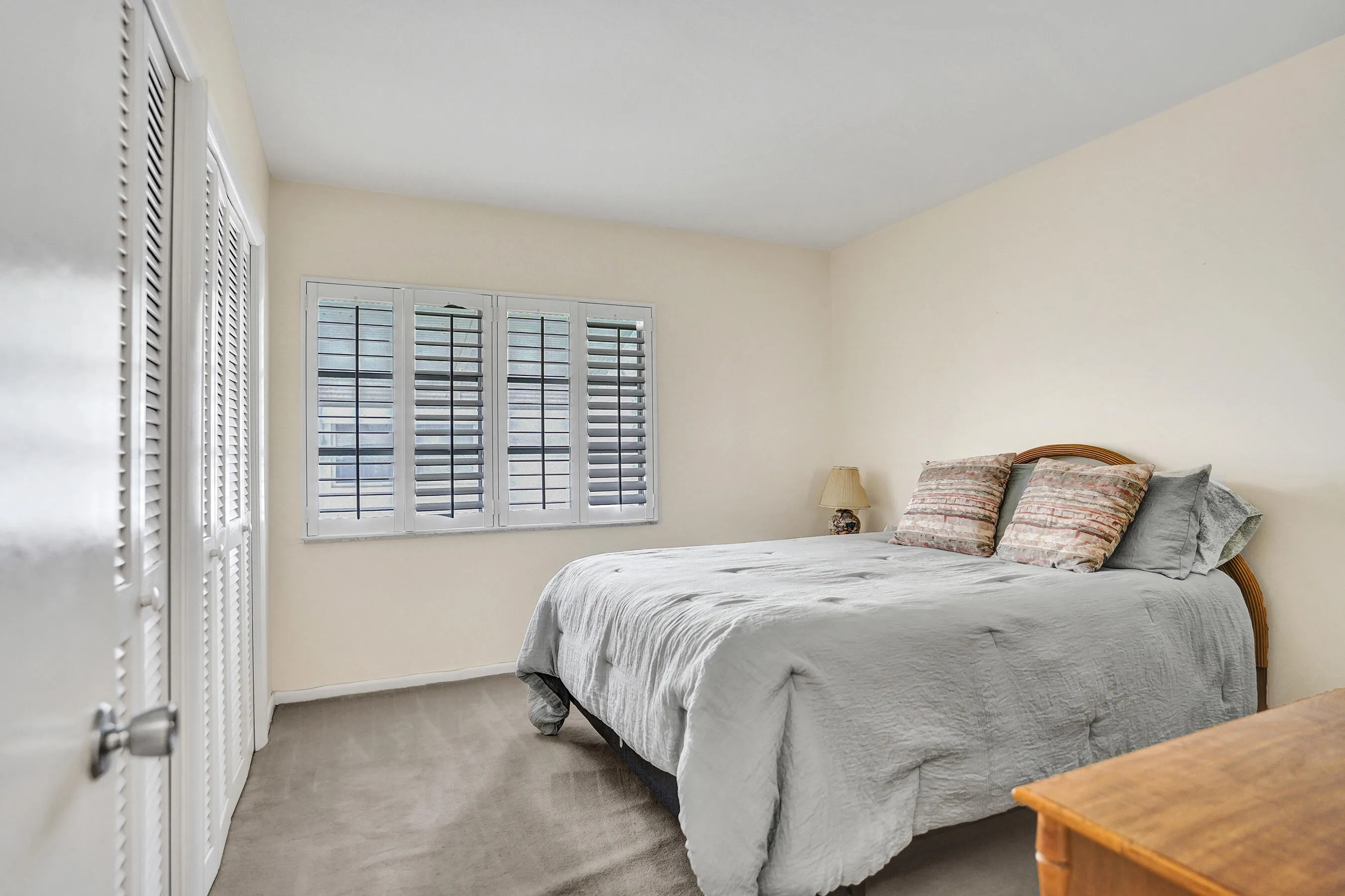 Neutral wall tones complement the carpeted flooring
