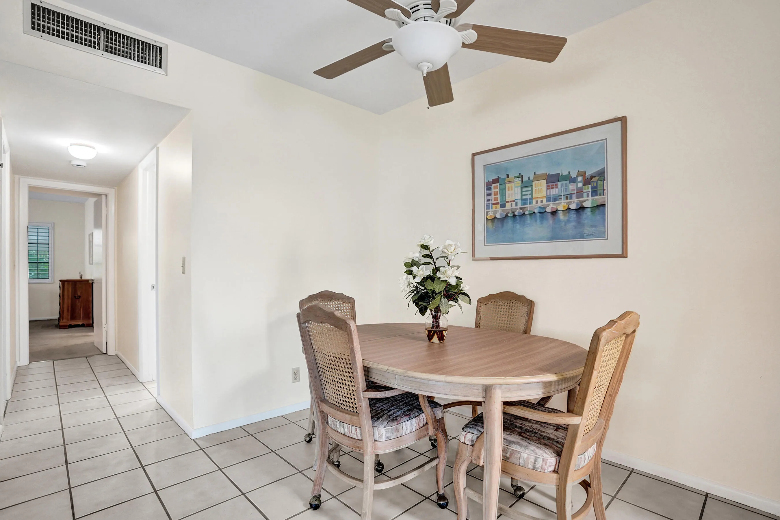 Dining area with neutral wall color and ceiling fan