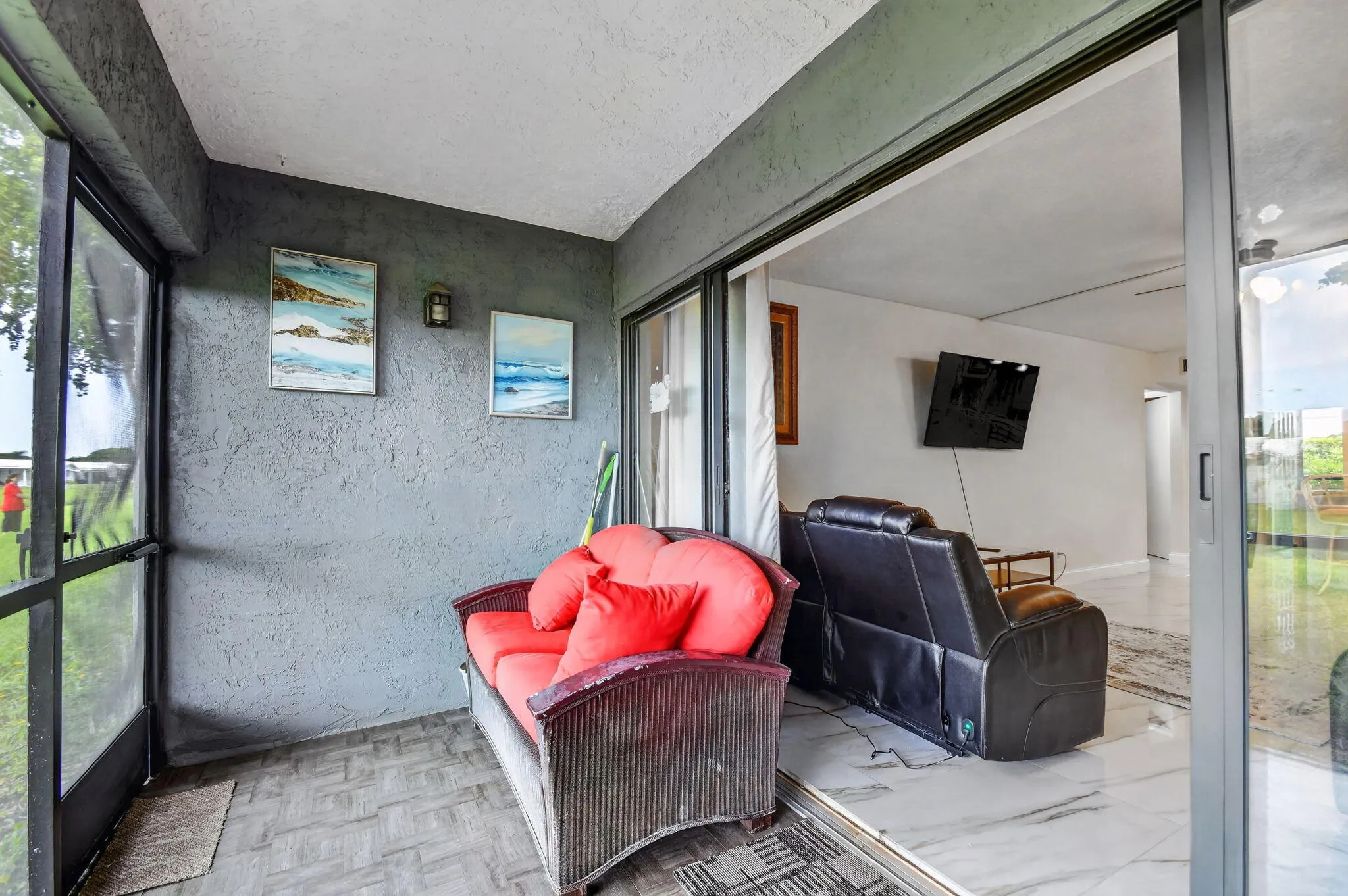 Screened patio with textured gray walls and patterned flooring
