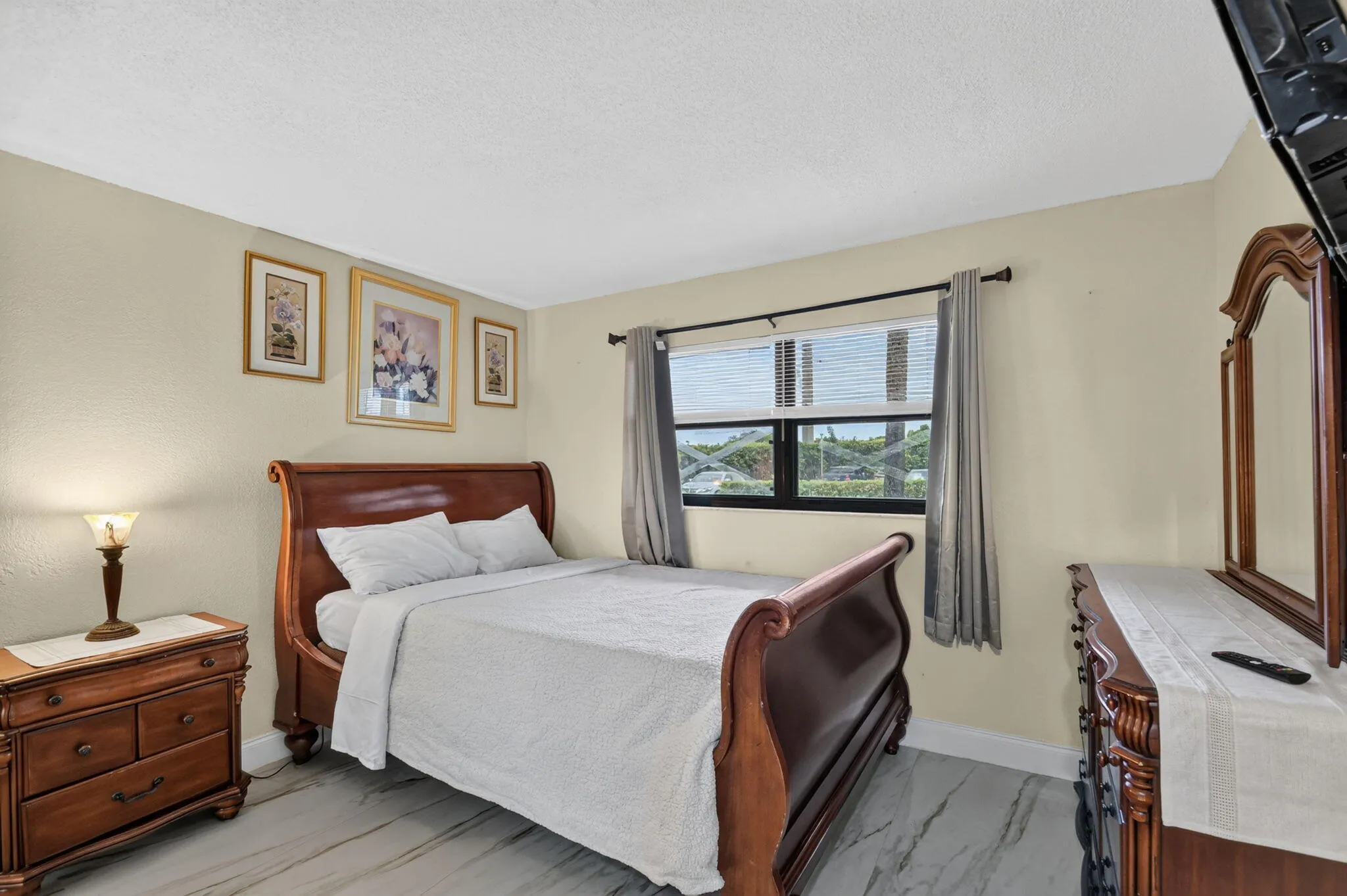 Room featuring light-toned walls and wood-finish flooring