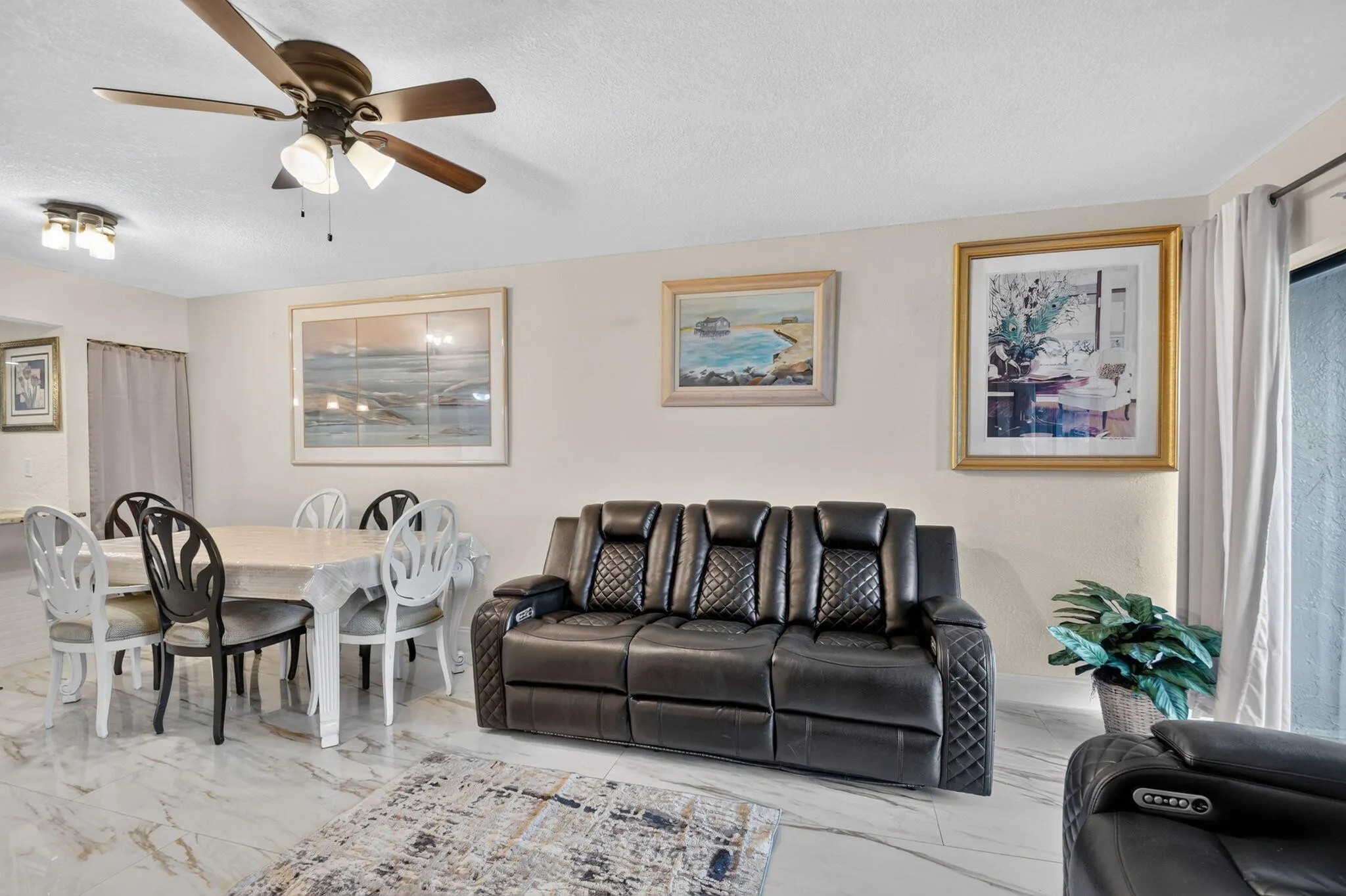 Spacious living area featuring polished tile flooring and neutral wall tones