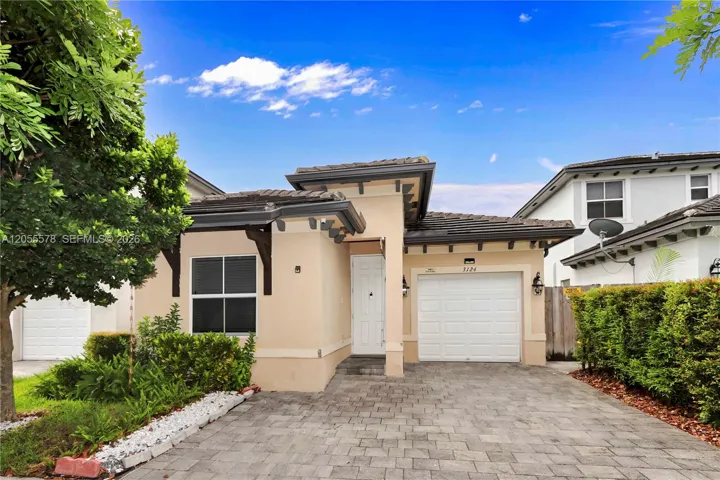 Welcome home! Featuring a beautifully maintained exterior, this residence offers a clean, inviting entrance complete with a private garage and ample driveway parking, perfectly blending curb appeal with everyday convenience