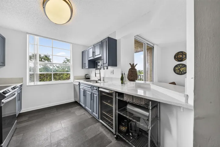 Updated kitchen featuring quartz countertops, stainless steel appliances, and modern finishes.