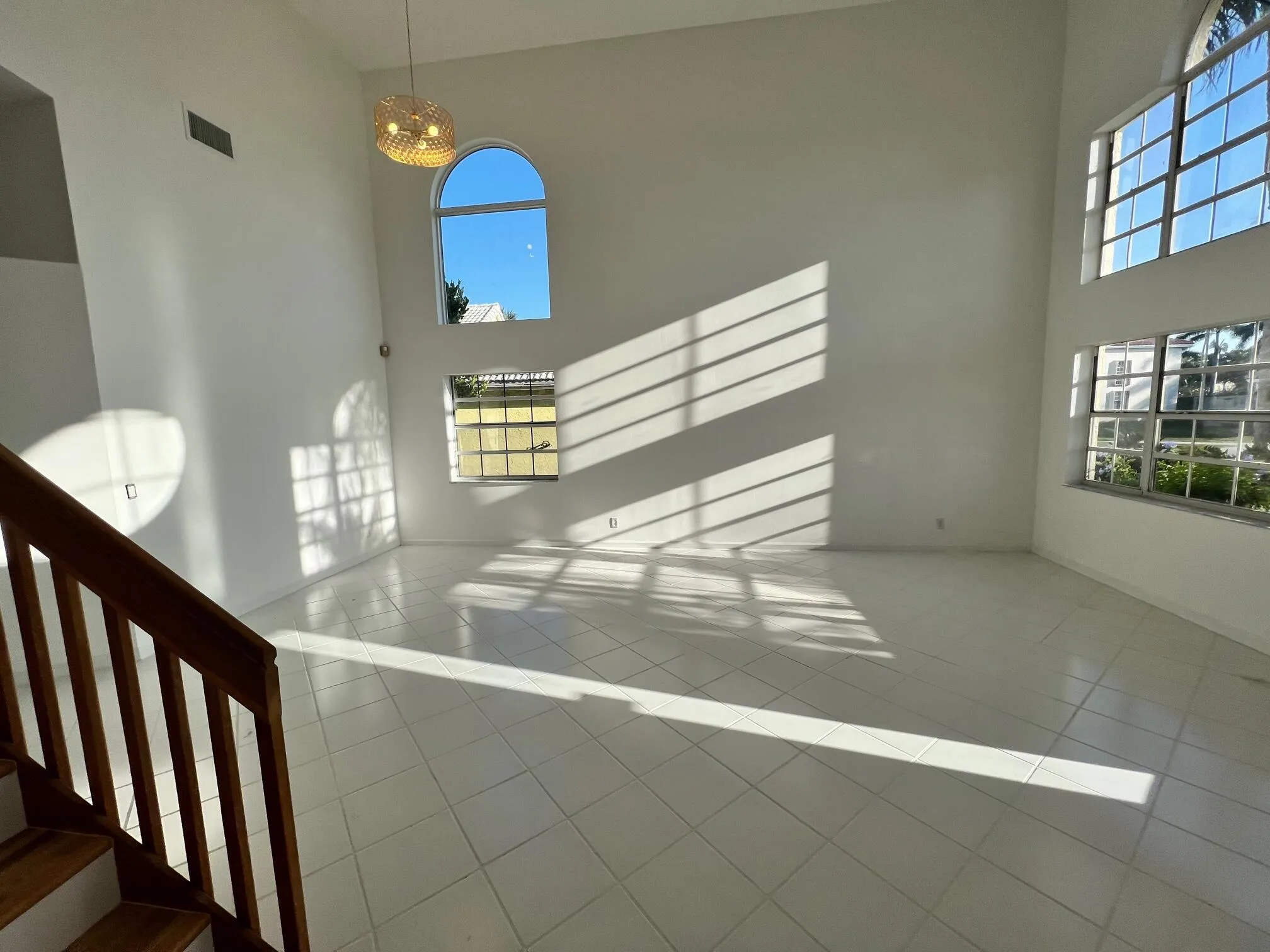Volume-rich interior featuring high ceilings and multiple windows