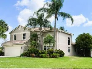 Mediterranean-style residence featuring a stucco exterior and barrel tile roof