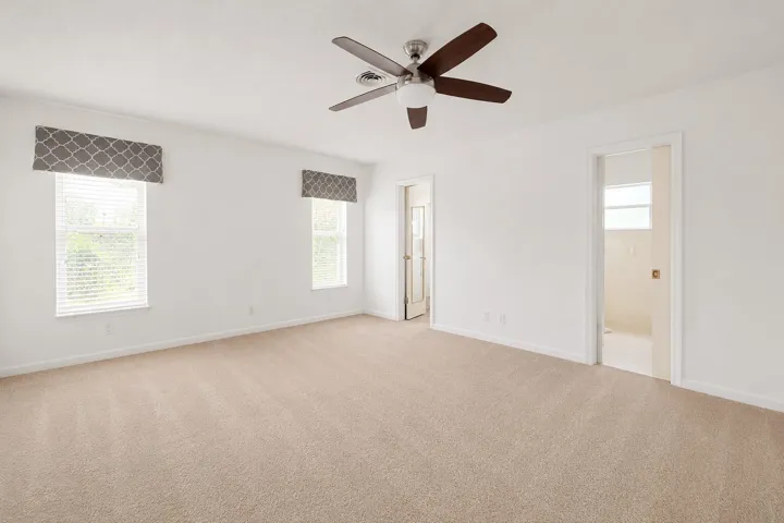 Spacious room featuring neutral carpeting and white walls