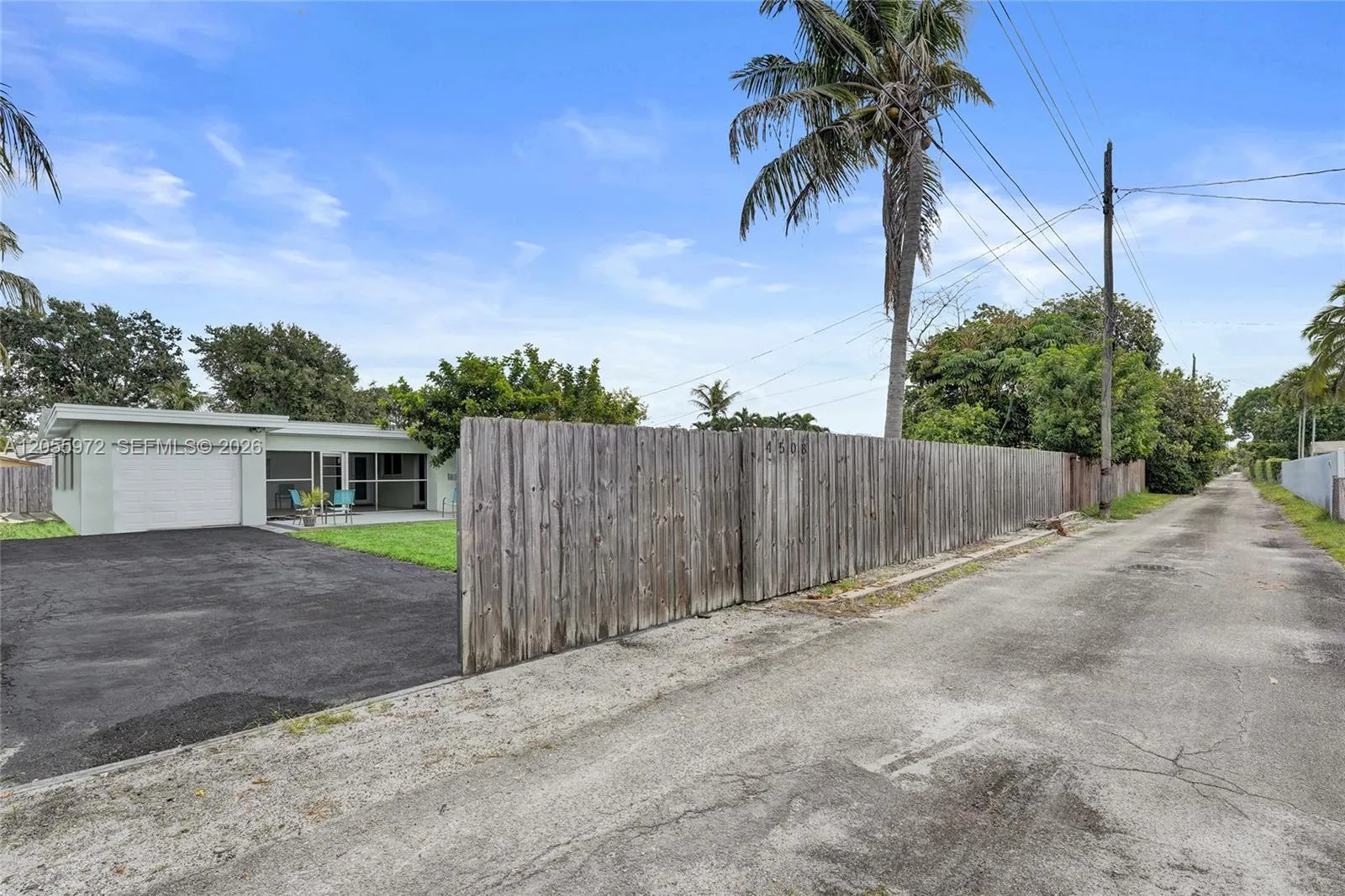 Alley in rear of home with entrance to driveway and garage