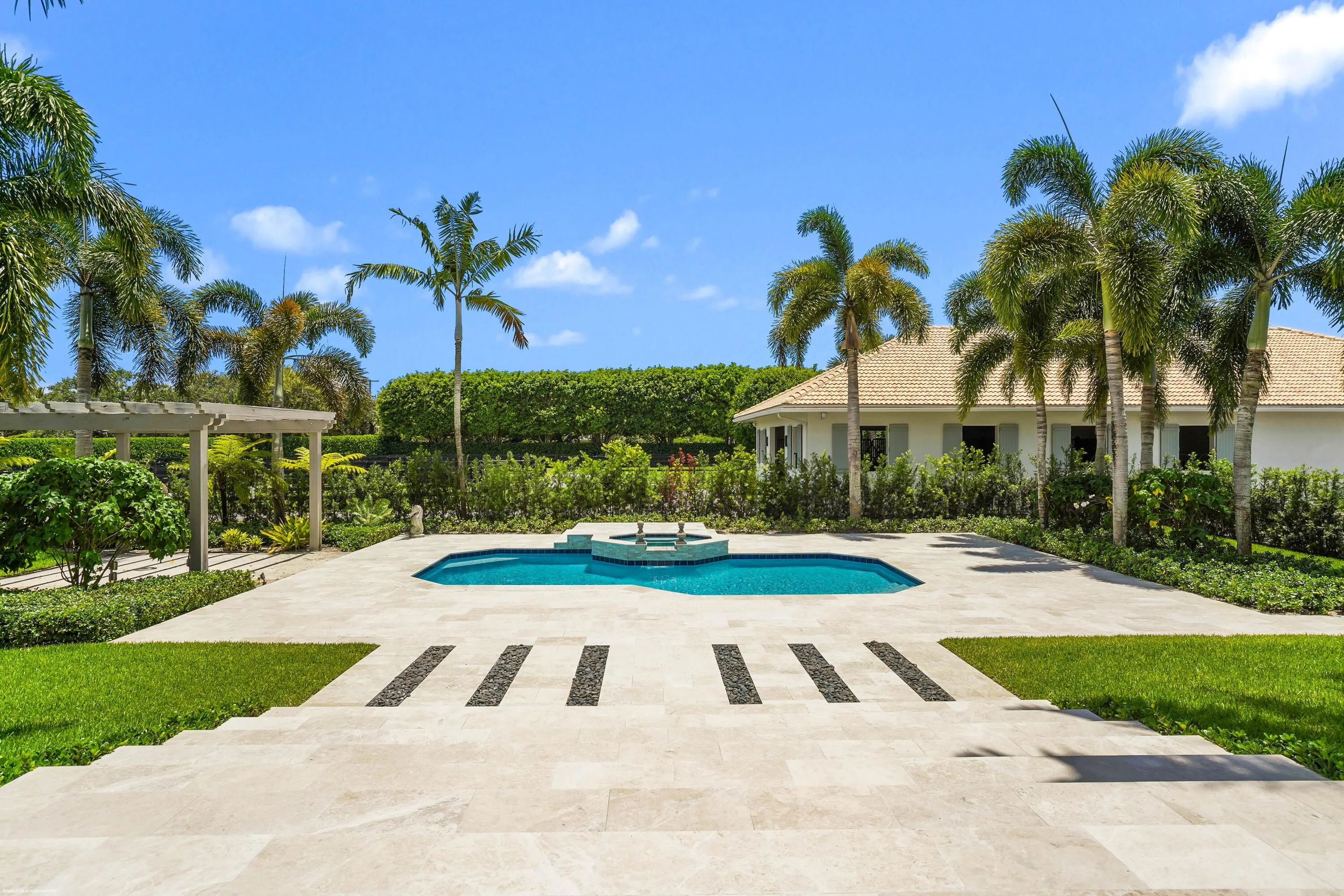 Pool & patio with stable beyond.