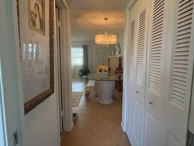 hallway closet leading to living room from bedroom