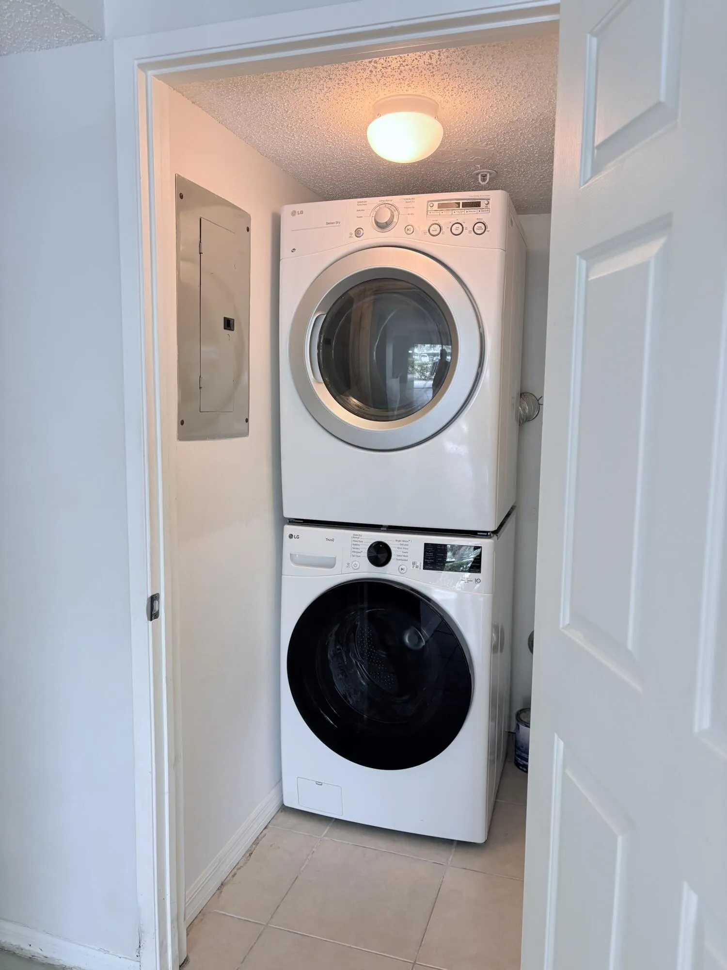 Full size washer and dryer in a separate laundry closet.